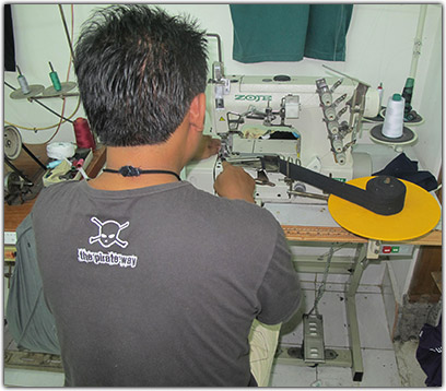 Dimyadi sewing a t-shirt